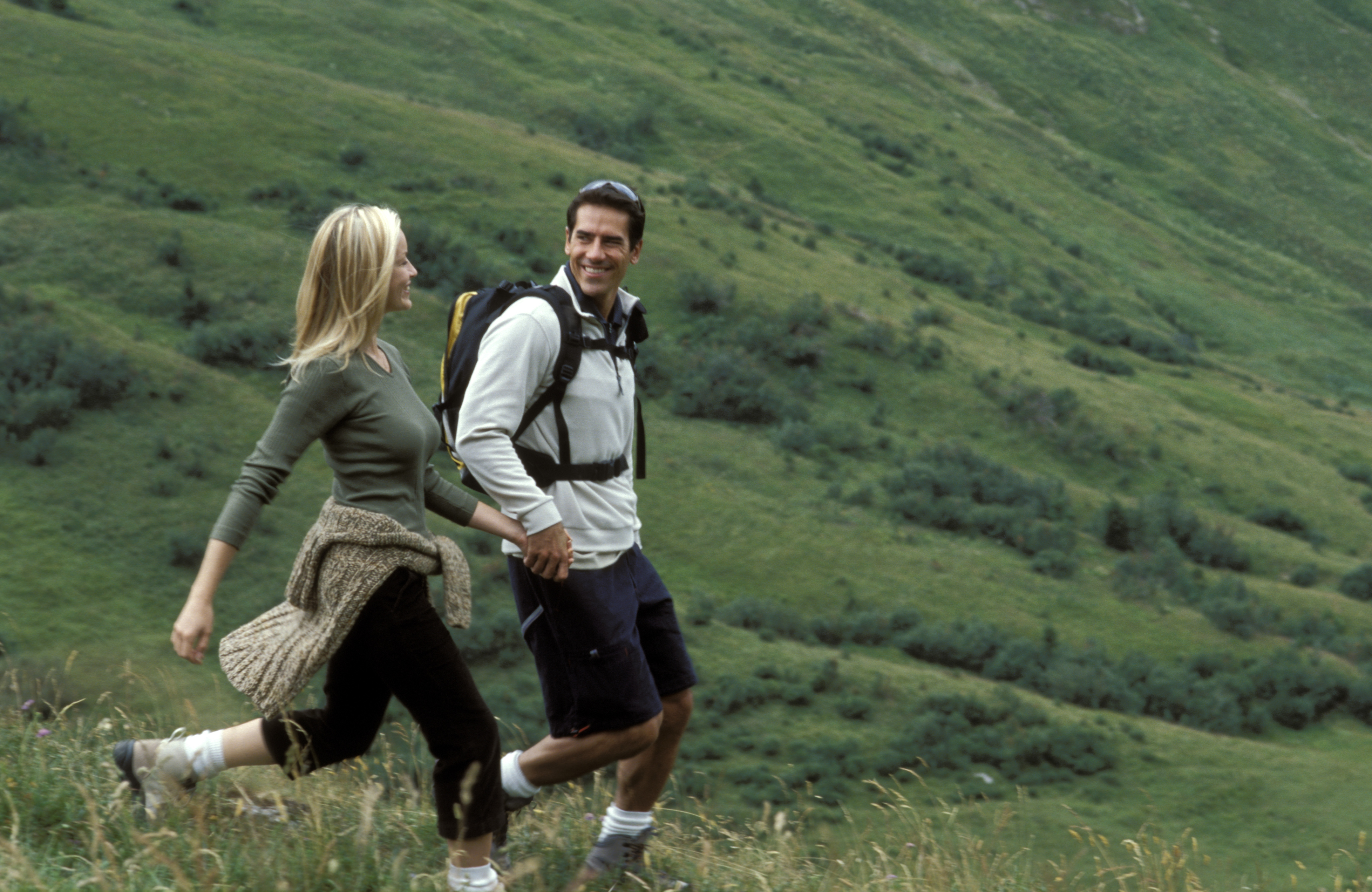 1,000 albums Man and woman hiking on mountainside